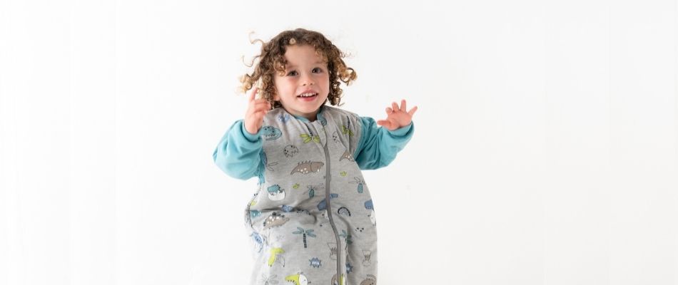 boy jumping in sleeping bag with feet