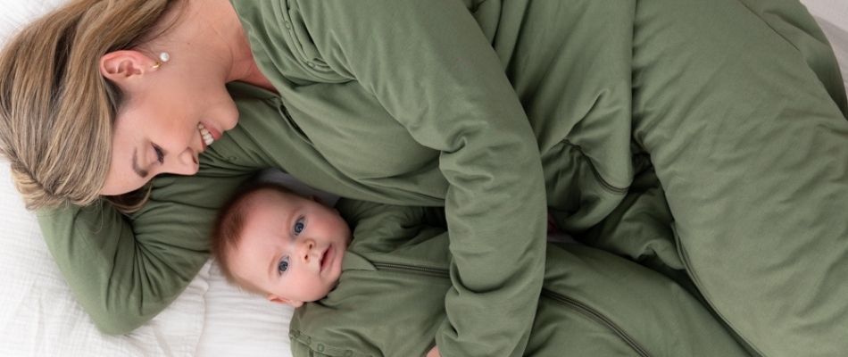 mum with baby in matching green sleeping bags