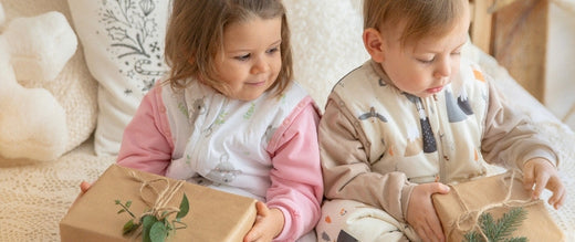 boy and girl in sleeping bags with feet opening gifts