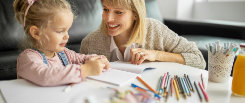 girl colouring with her mum