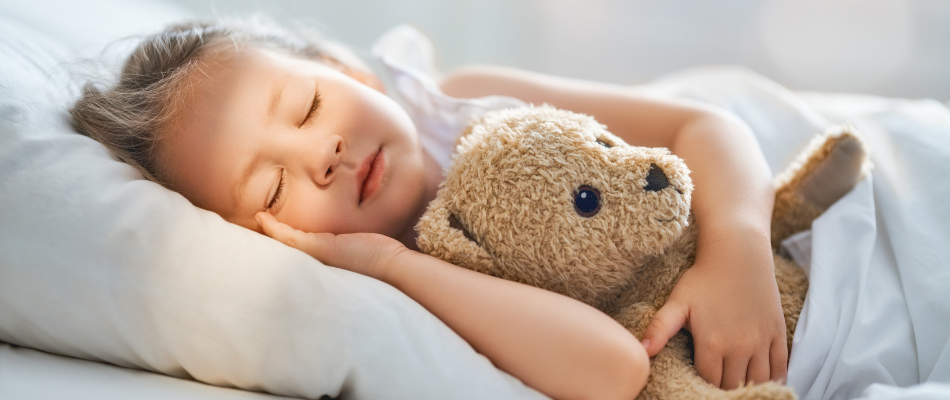 Girl sleeping with her teddy bear