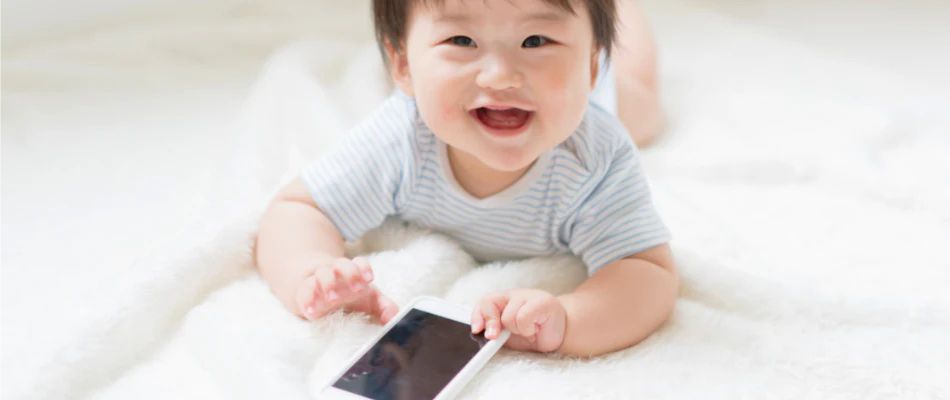 baby holding mobile phone