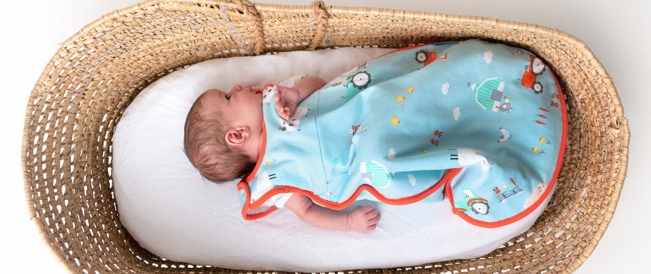 baby in crib in sleeping bag