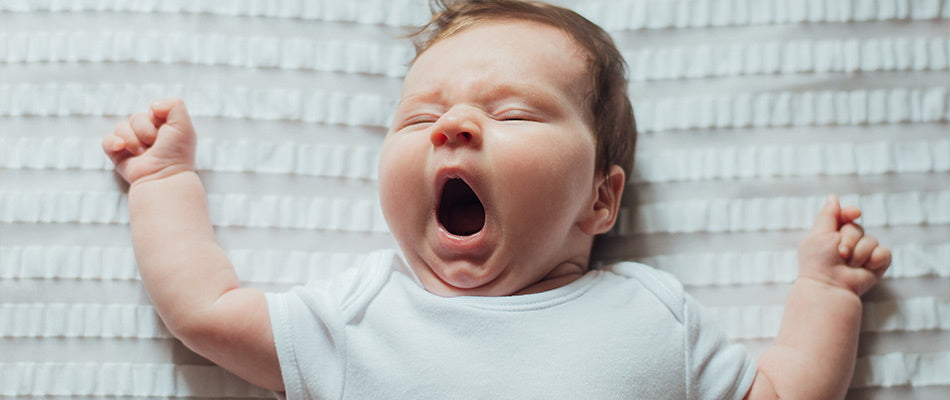 baby yawning in bed