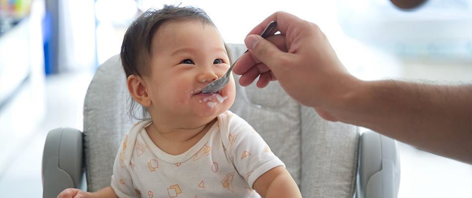 baby eating in high chair