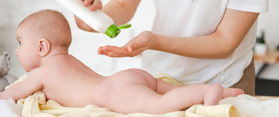 parent putting cream on baby