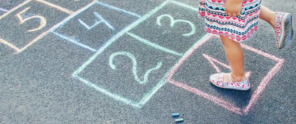 child playing hopscotch