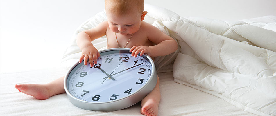 baby with giant clock