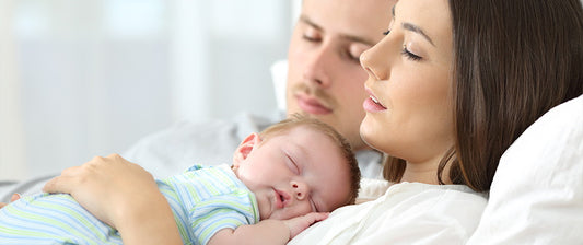 parents sleeping with their baby