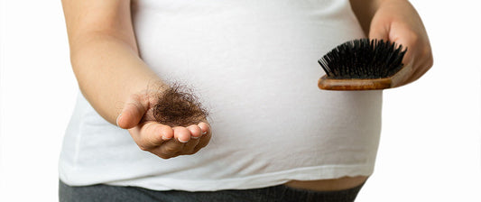 pregnant woman with hair brush showing hair loss