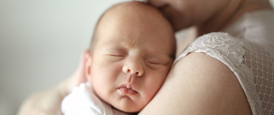 baby asleep on mum's shoulder