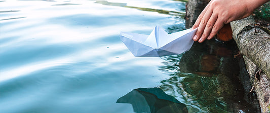 paper boat on lake