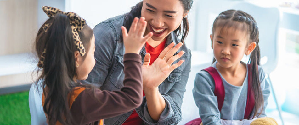 mum clapping hands with two girls